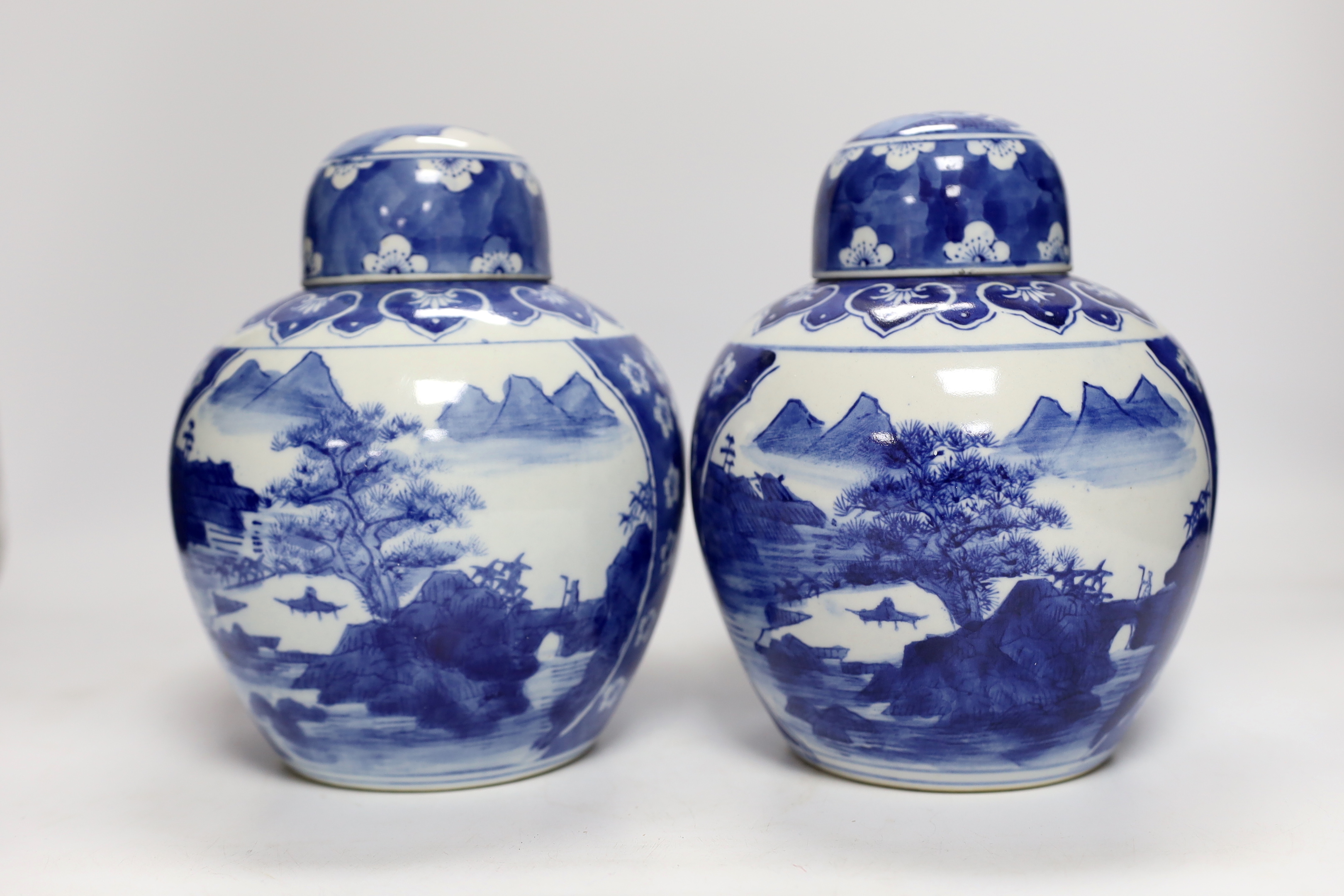 Four Chinese ginger jars, including a blue and white pair with covers and a prunus flower example, largest 21cm high